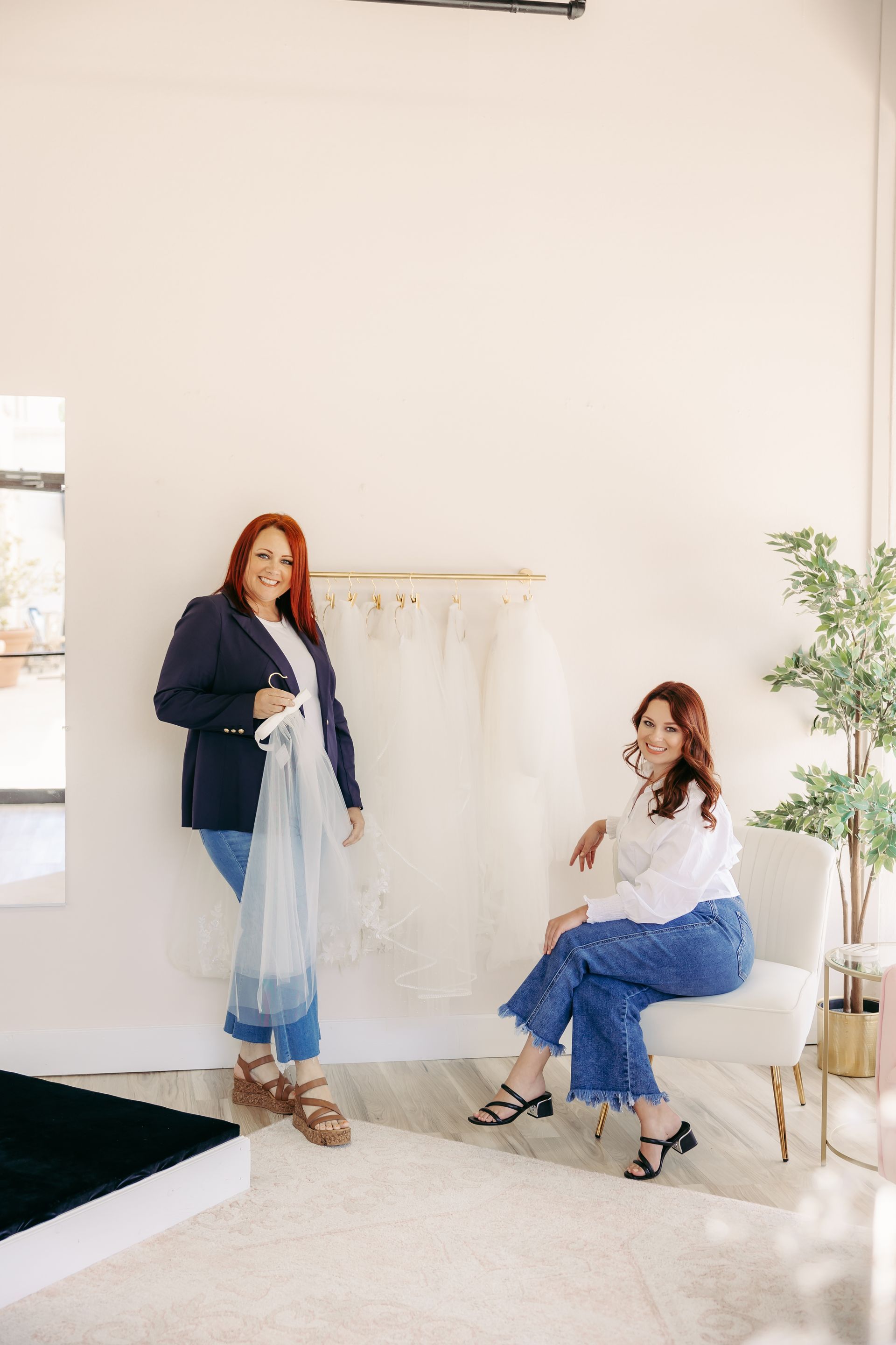 Two women are standing next to each other in a room.