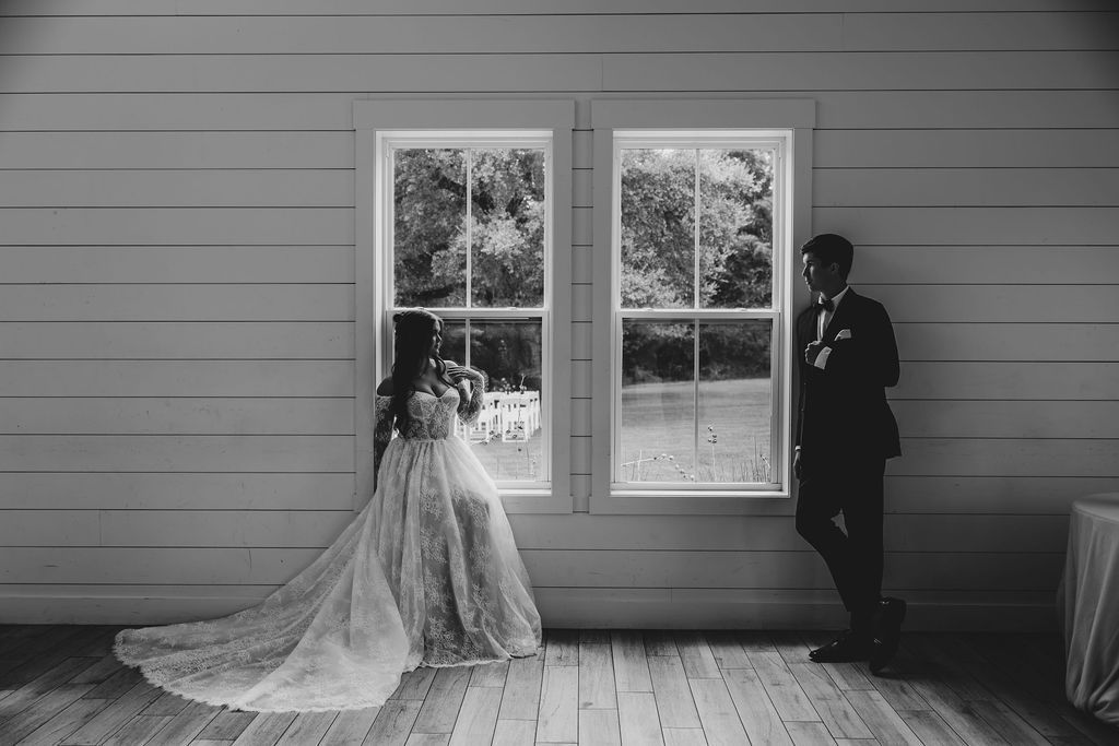 A bride in a white dress is holding a bouquet of flowers in her hands.