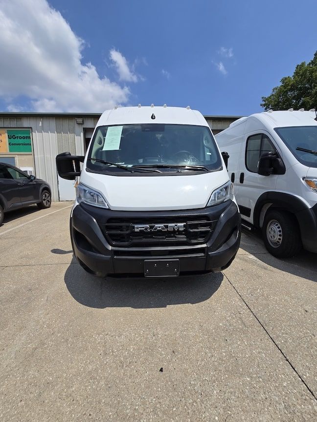 White Ram ProMaster van parked outdoors on concrete.