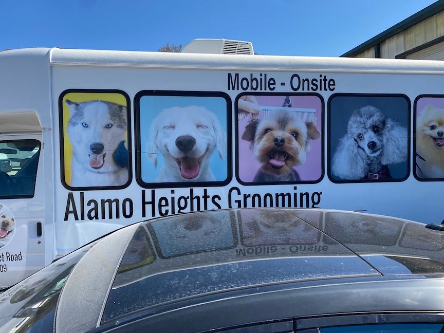 Mobile grooming van with dog portraits;
