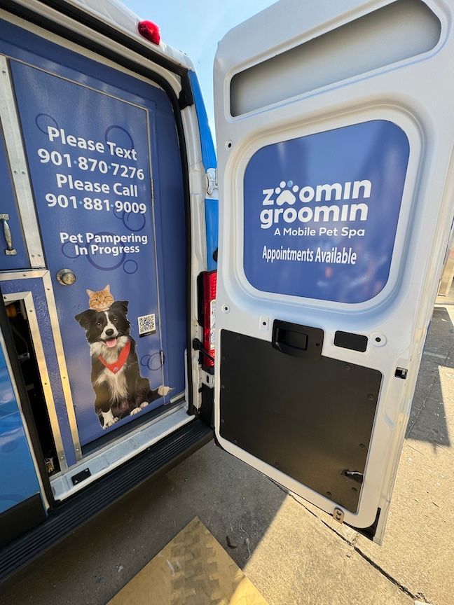 Open door of a white grooming van with