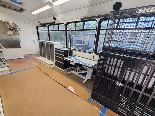 A room with a table and a cage in it.