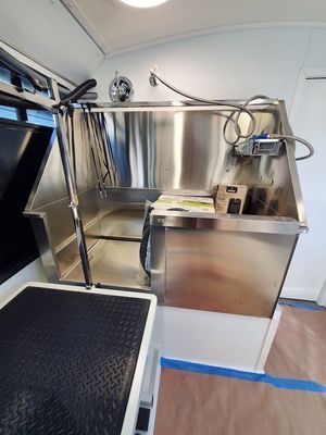 There is a stainless steel sink in the middle of the room.