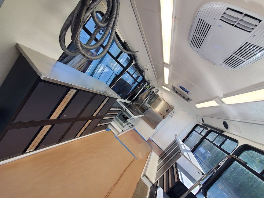 A room with a lot of windows and a ceiling fan