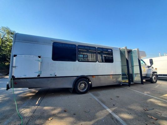 A large white bus is parked in a parking lot.
