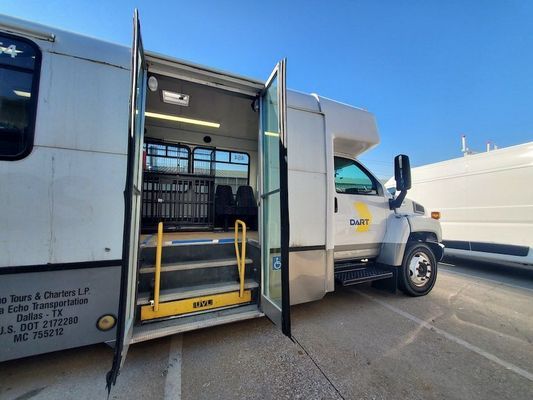 A white van with the doors open is parked in a parking lot