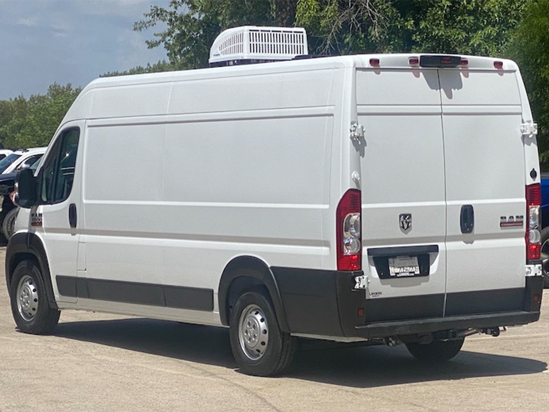 A white van is parked in a parking lot.