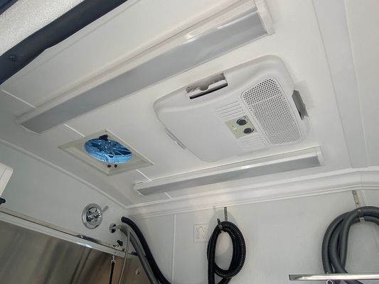 A white ceiling with a fan and lights on it