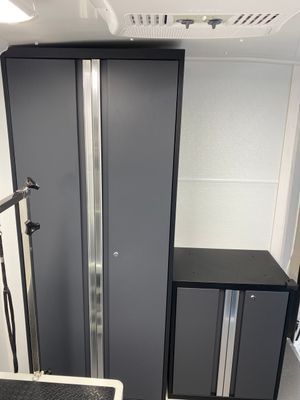 A room with a lot of cabinets and a ceiling fan.