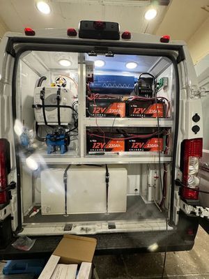 The back of an ambulance with a lot of batteries in it.
