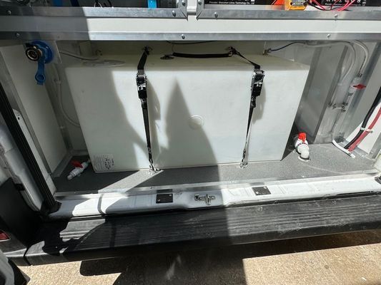 A large white tank is sitting in the back of a vehicle.