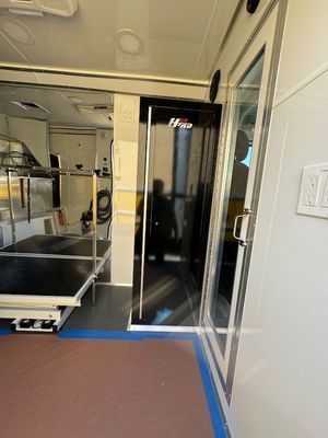 A room with a table and a door in it.