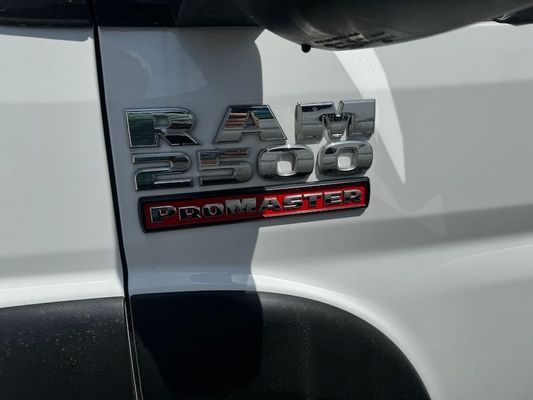 The side of a white ram 2500 promaster truck