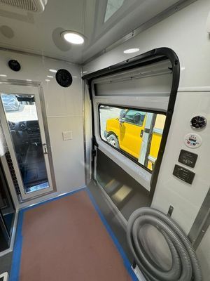 The inside of an ambulance with a yellow truck parked in the background.