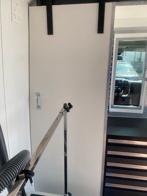 A vacuum cleaner is sitting in a room next to a door.