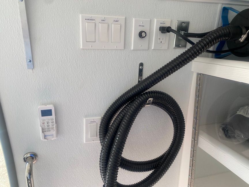 A vacuum hose is attached to a white wall