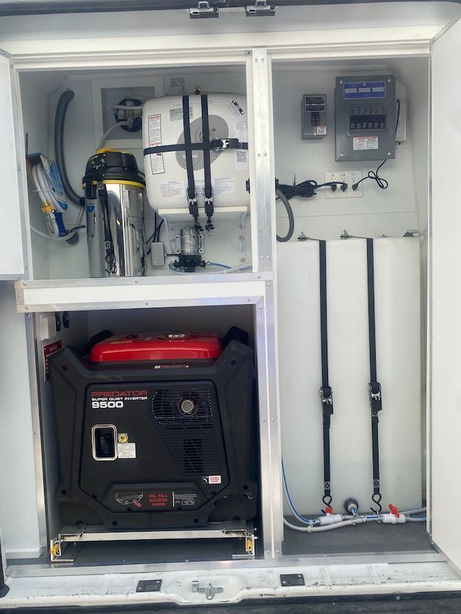 The inside of a van with a generator and a vacuum cleaner