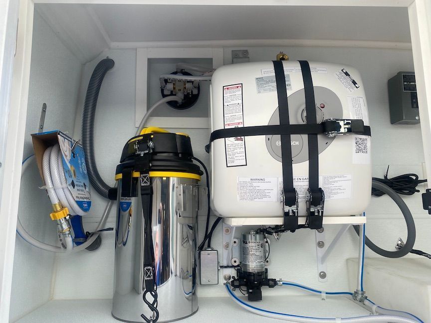 The inside of a cabinet with a vacuum cleaner and a life preserver