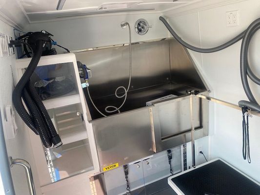 A dog grooming area with a stainless steel sink