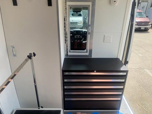 The inside of an ambulance with a mirror and drawers