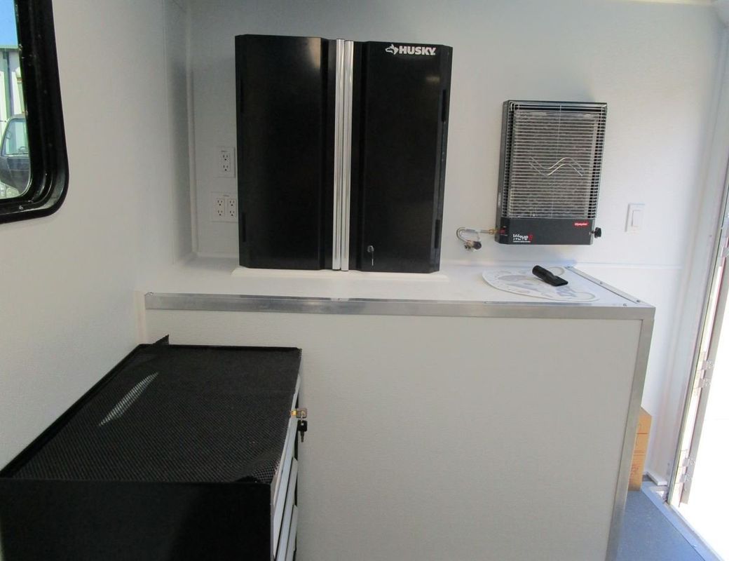 A white wall with two black cabinets on it