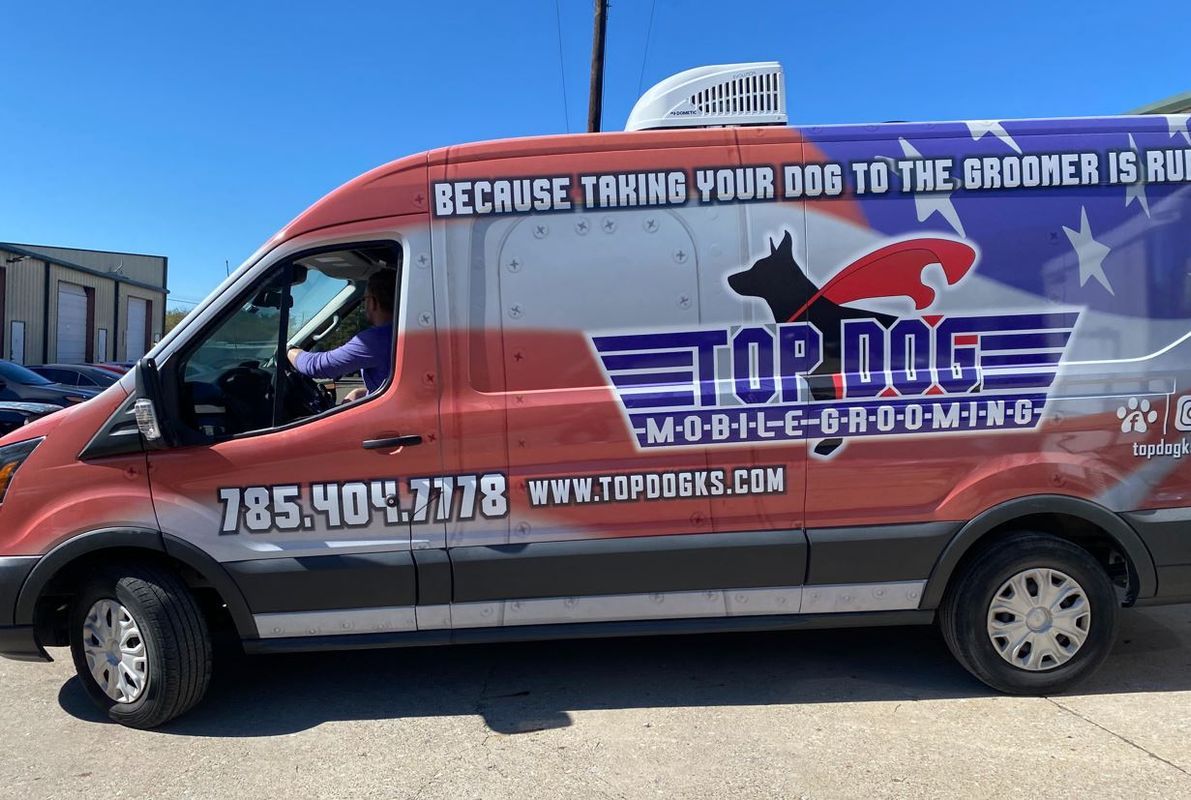 Professional mobile grooming van interior with tub, table, and grooming equipment