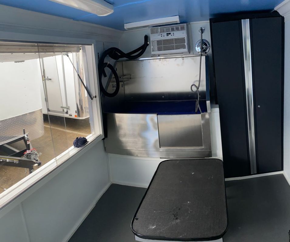 A small room with a sink and a window