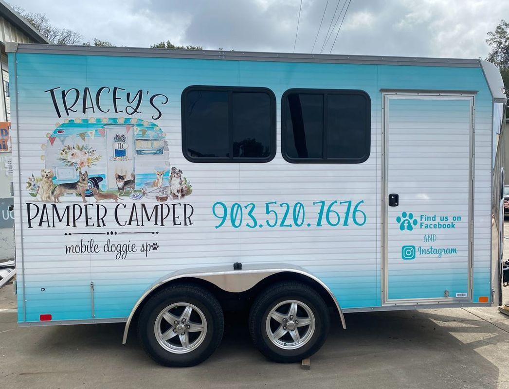 A blue and white trailer with a phone number on it