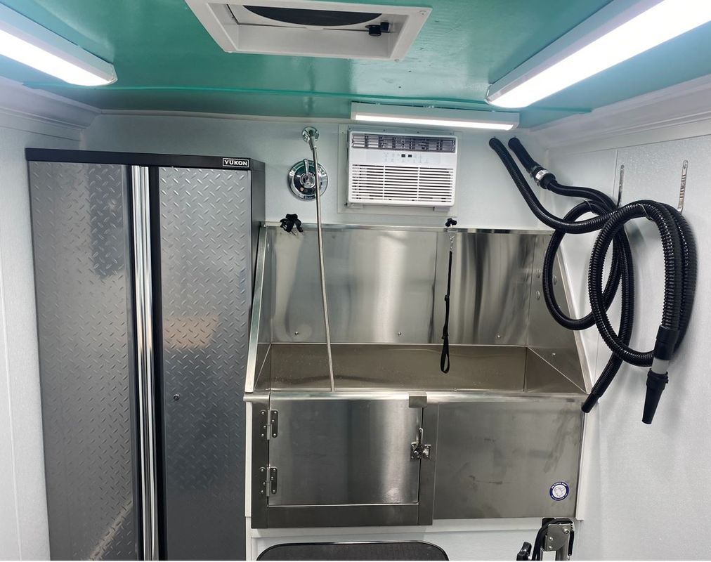 A stainless steel sink with a hose attached to it