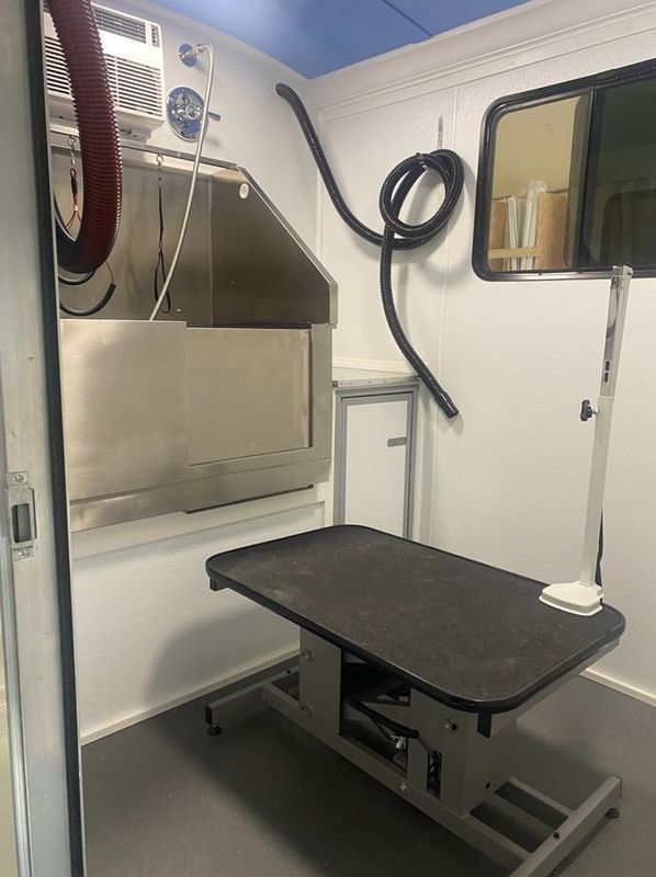 A room with a table and a sink in it.