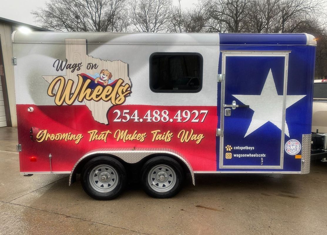 A trailer that says wings on wheels on it