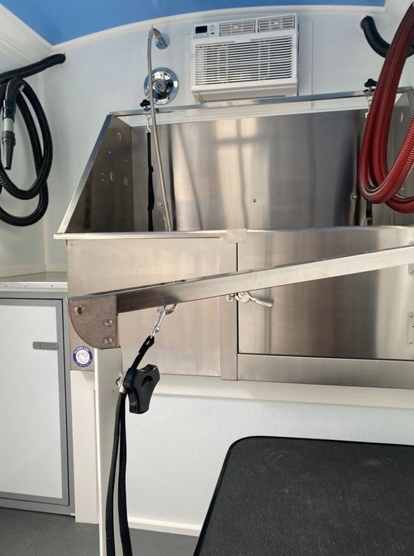 A stainless steel sink with a hose attached to it