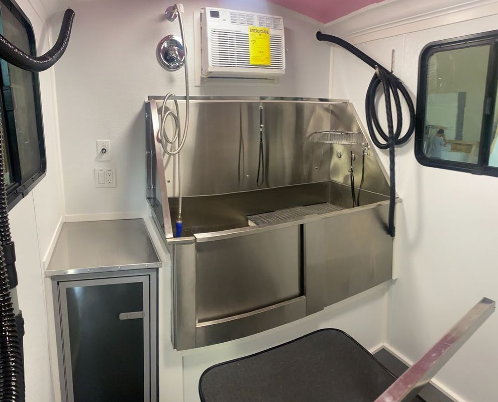 There is a stainless steel sink in the middle of the room.