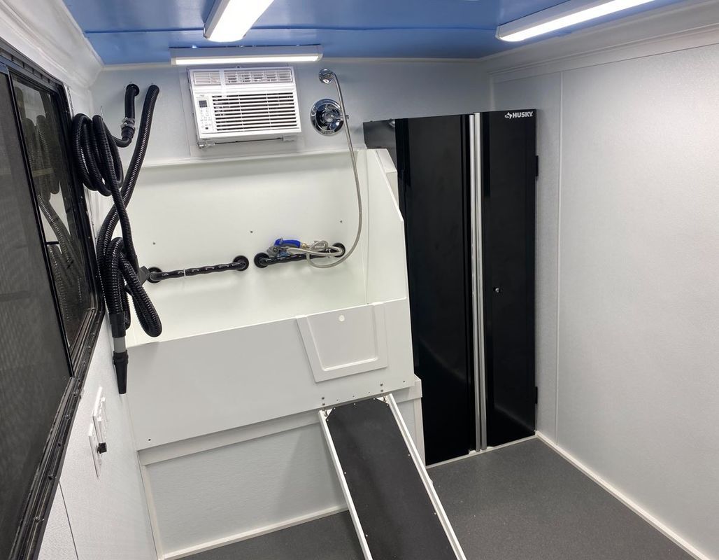 A white room with a blue ceiling and a black door