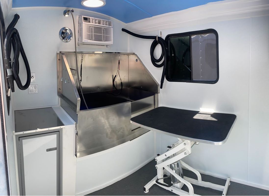 A room with a table and a sink in it.