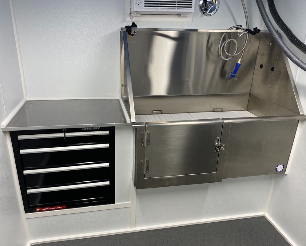 A stainless steel sink with a hose attached to it