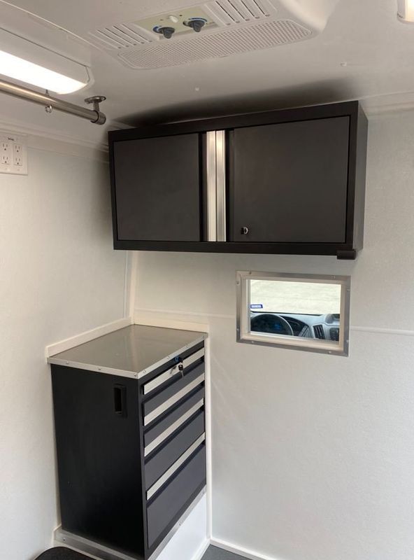 A room with a cabinet and a mirror on the wall.