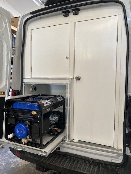 A generator is sitting in the back of a van