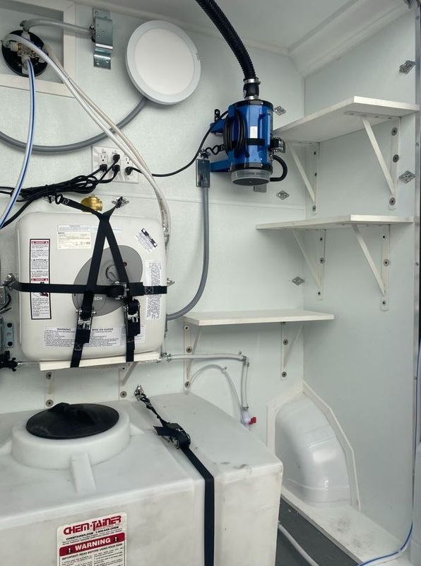 A white tank with a sign that says emergency on it