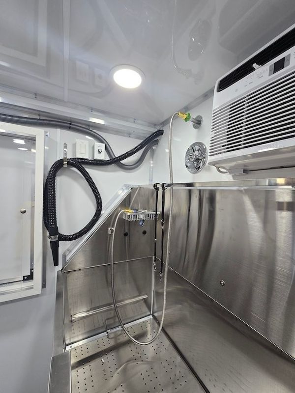 A stainless steel shower with a hose attached to it.