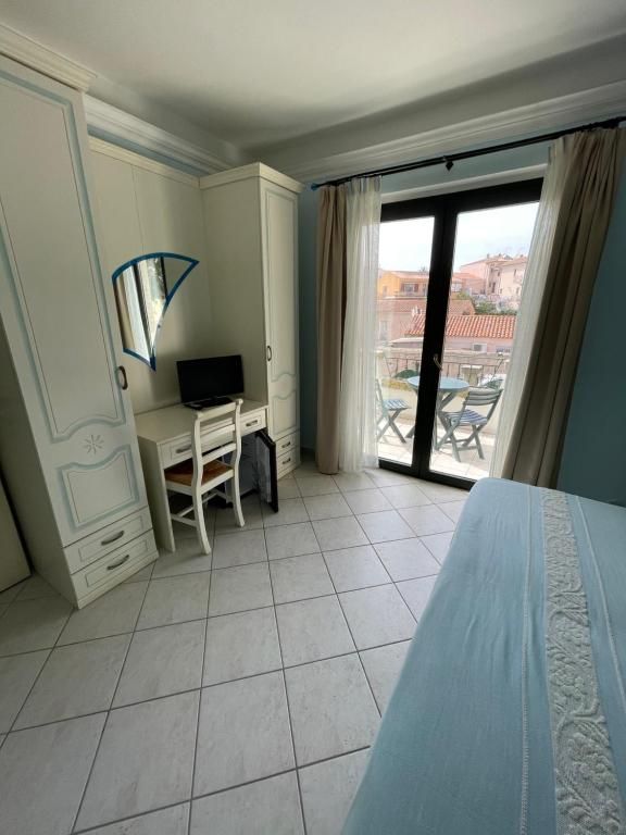 Una camera da letto con un letto, una scrivania e un balcone