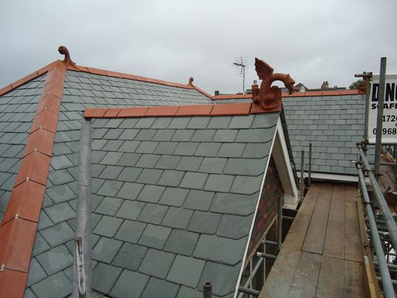 brazilian slate, hipped roof, finials, dragon finial, scroll top finial, red ridge slate roof