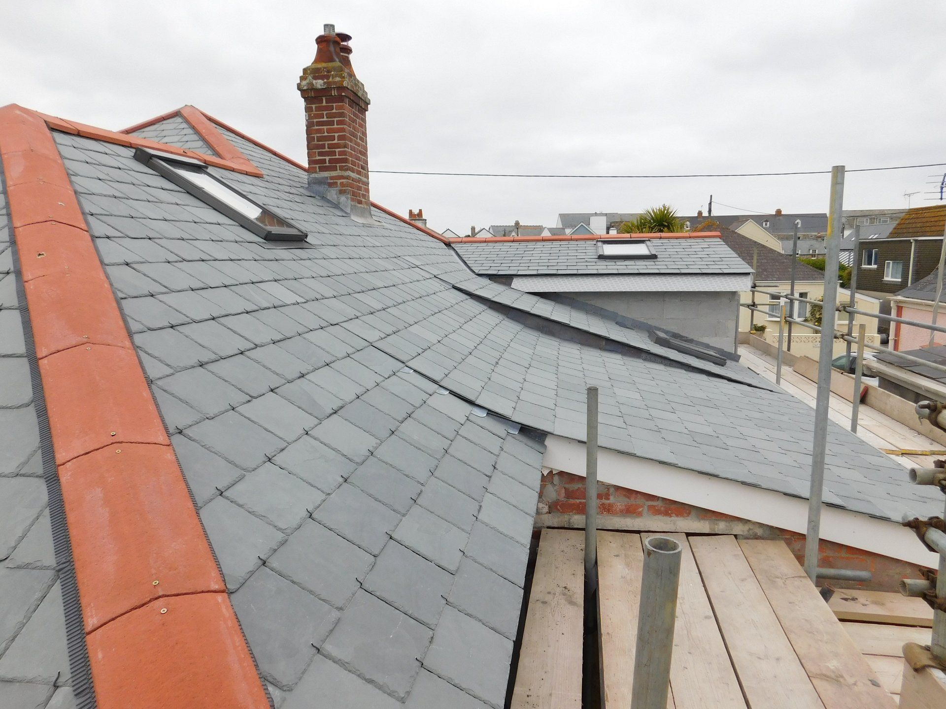 Reroof Brazilian slate, cat slide roof, velux window, red ridge, red clay hip, clay ridge, lead chimney, slate roof, M.A.R Roofing