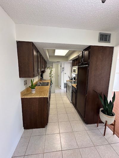 An empty room with hardwood floors and a large window.