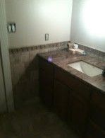 A bathroom with a sink and a mirror.