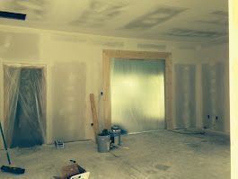 A room that is being remodeled with drywall on the walls and ceiling.