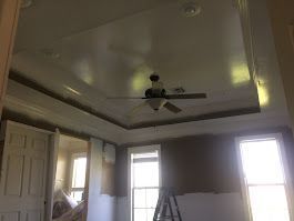 A ceiling fan is hanging from the ceiling of a room.