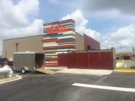 A large building with a trailer parked in front of it.