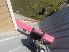 A person is sitting on the roof of a building.