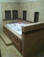 There is a bathtub in the middle of the bathroom.